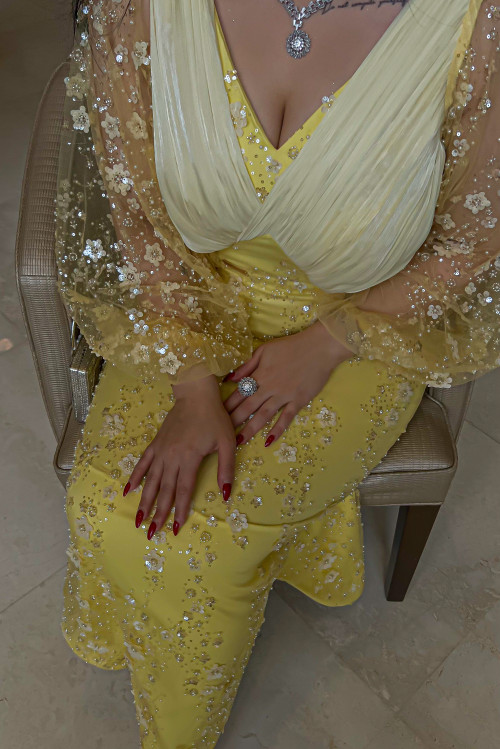 A stunning evening dress in bright yellow color that adds radiance and attractiveness