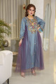 An innovative traditional dress in turquoise with layers of purple tulle