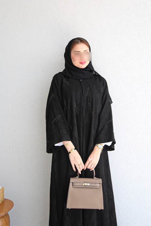 Black abaya patterned with leaves