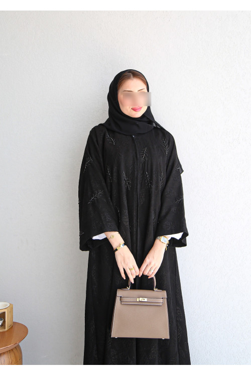 Black abaya patterned with leaves