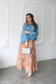 A sky blue linen shirt set with a rose on the shoulder and an apricot printed skirt