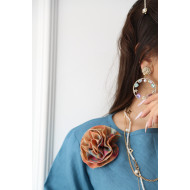 A sky blue linen shirt set with a rose on the shoulder and an apricot printed skirt